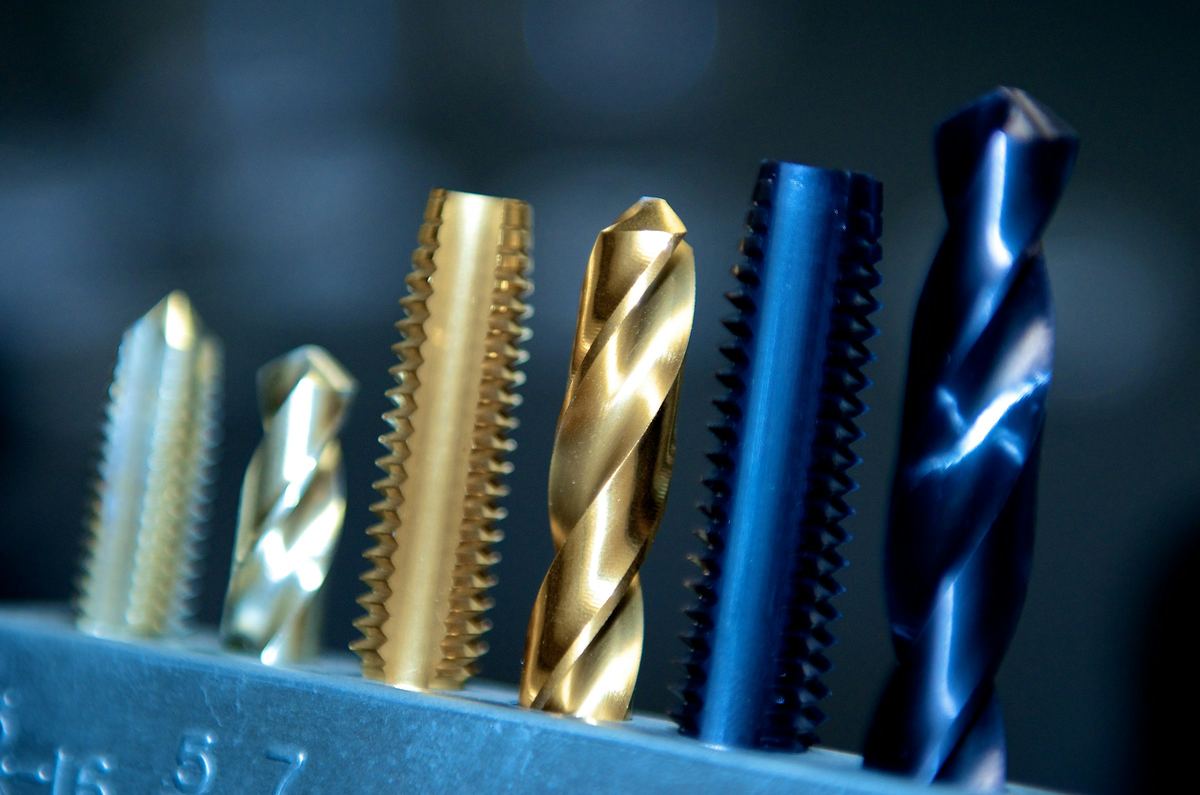 Coated drills and cutting tools standing in a tool rack